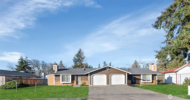 ranch-style home with a garage, fence, driveway, a chimney, and a front yard