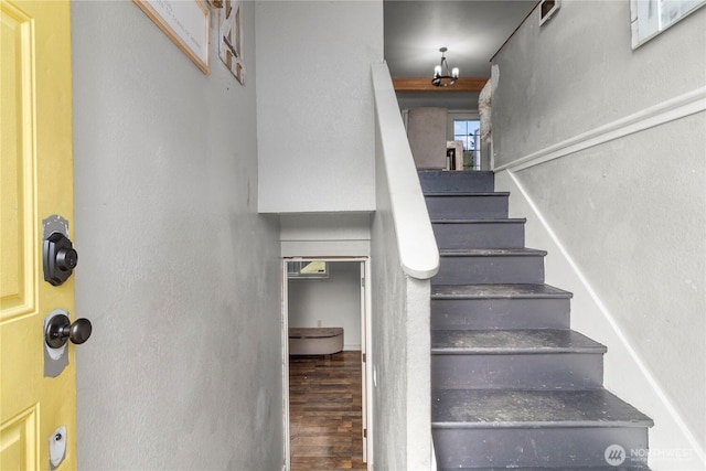 stairs featuring wood finished floors