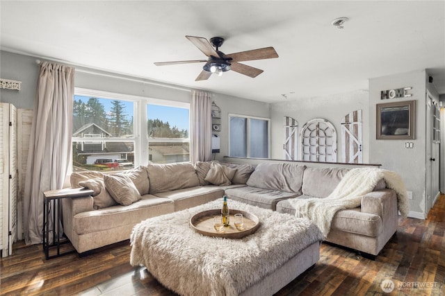 living room with dark wood-type flooring and a ceiling fan