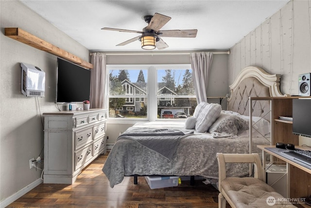 bedroom featuring a ceiling fan, baseboards, and wood finished floors