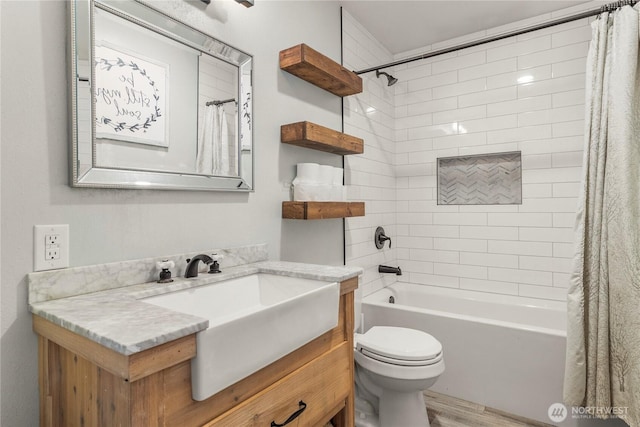 bathroom with wood finished floors, vanity, toilet, and shower / bathtub combination with curtain