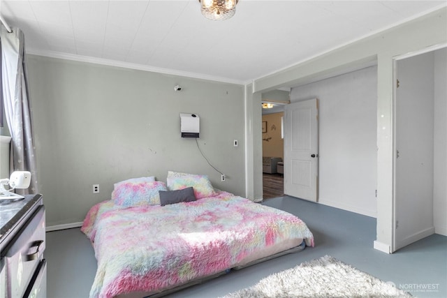 bedroom with concrete floors, baseboards, and crown molding