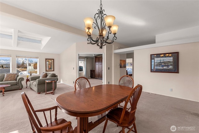 dining room with light colored carpet, beamed ceiling, and an inviting chandelier