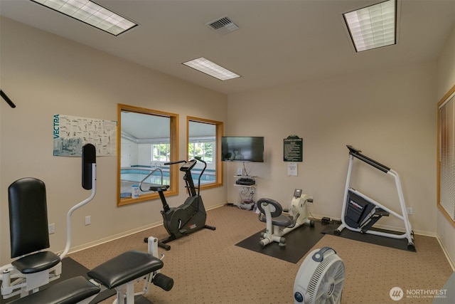 workout room featuring visible vents and baseboards