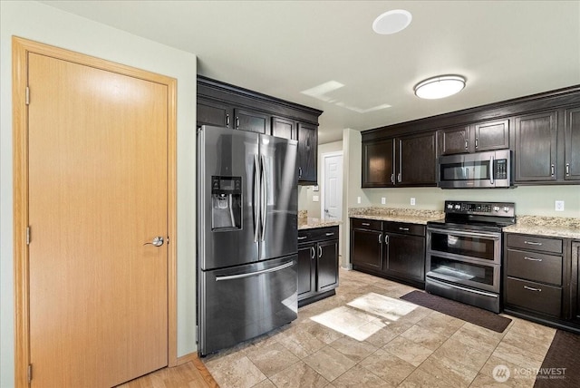 kitchen featuring light stone countertops and stainless steel appliances