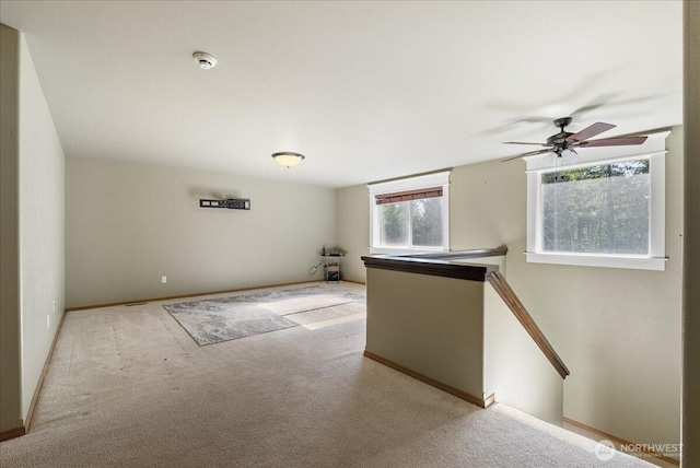 spare room with baseboards and carpet flooring