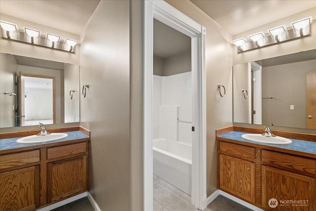 bathroom featuring shower / bathtub combination, tile patterned flooring, vanity, and baseboards