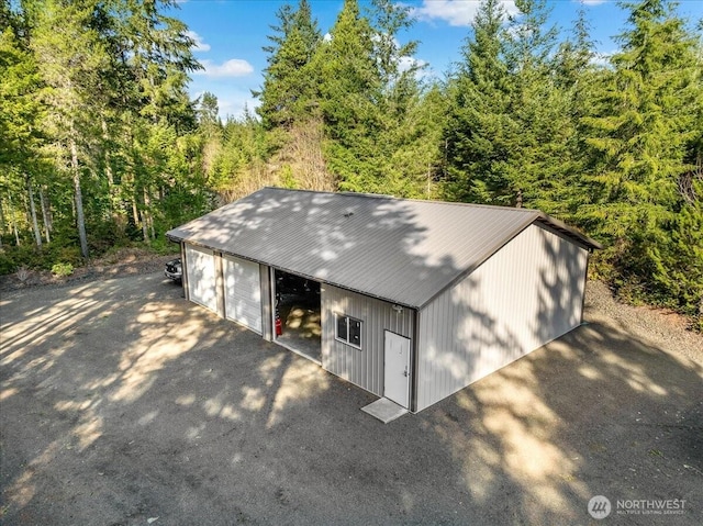 view of outbuilding with an outdoor structure and a view of trees