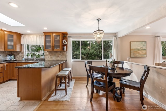 dining space featuring recessed lighting, a healthy amount of sunlight, and a skylight