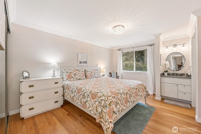 bedroom with light wood finished floors and ornamental molding