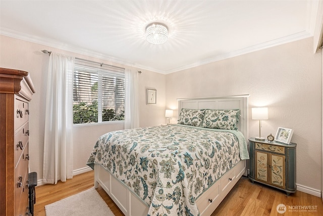 bedroom with light wood-type flooring, baseboards, and ornamental molding