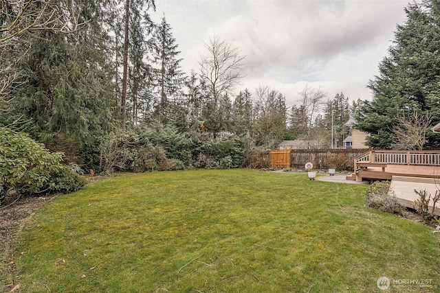 view of yard featuring a deck and fence