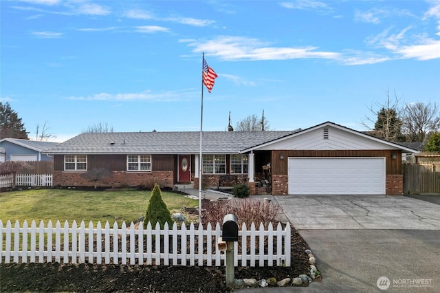 ranch-style home with a fenced front yard, a front yard, brick siding, and a garage