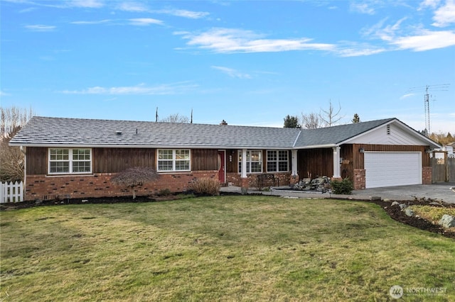 ranch-style house with a garage, brick siding, driveway, and a front yard