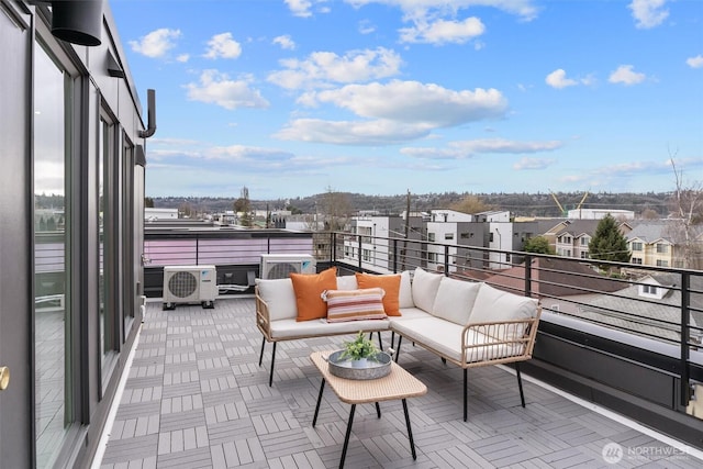 balcony featuring ac unit, a residential view, and an outdoor living space