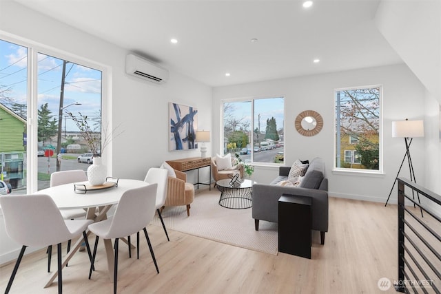 interior space featuring baseboards, an AC wall unit, light wood-style flooring, and recessed lighting