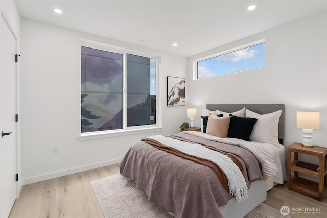 bedroom with baseboards, wood finished floors, and recessed lighting