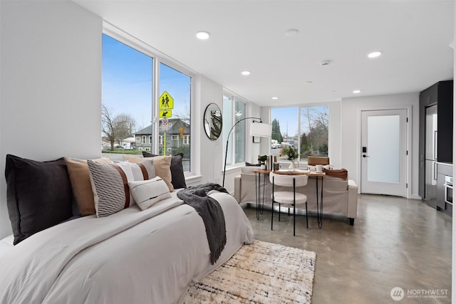 interior space with multiple windows, concrete flooring, and recessed lighting