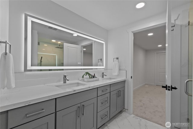 bathroom with double vanity, a sink, and a shower stall