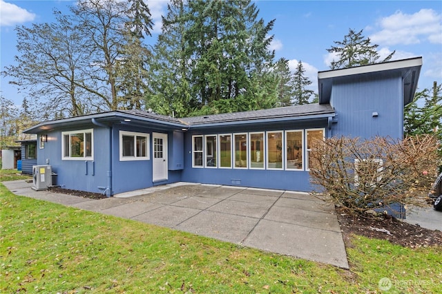 exterior space featuring central air condition unit, a patio area, and a front yard