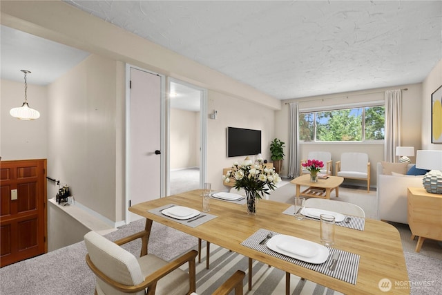 dining area featuring a textured ceiling