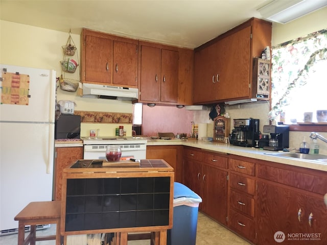 160 Gharet Rd, Randle, WA 98377 - kitchen with freestanding refrigerator, under cabinet range hood, a sink, and brown cabinets