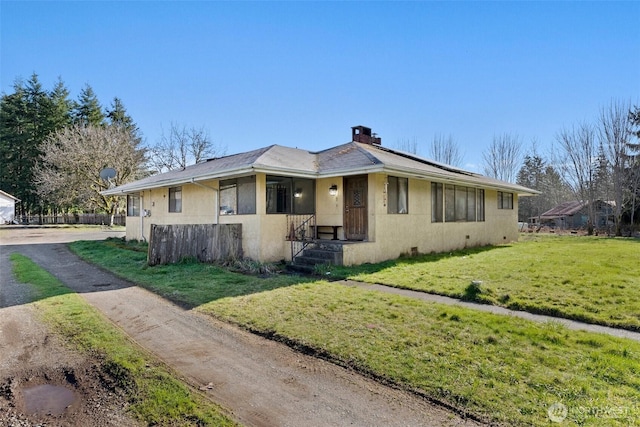 view of front of house with crawl space, a chimney, a front lawn, and stucco siding