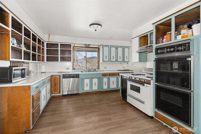 kitchen with dark wood finished floors, open shelves, stainless steel appliances, a sink, and under cabinet range hood