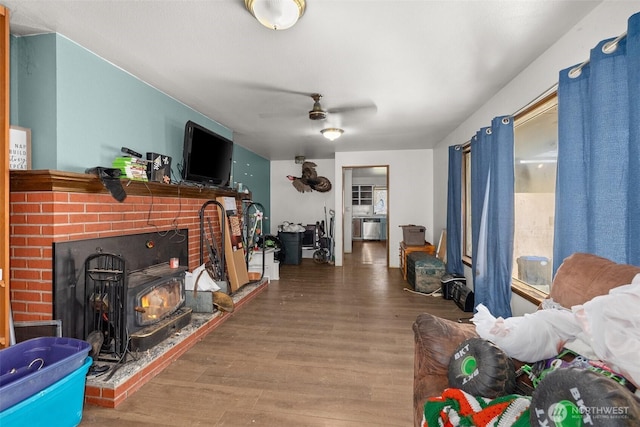 living room featuring a ceiling fan and wood finished floors