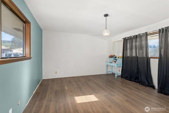 unfurnished room with wood finished floors