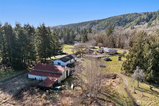 birds eye view of property with a wooded view