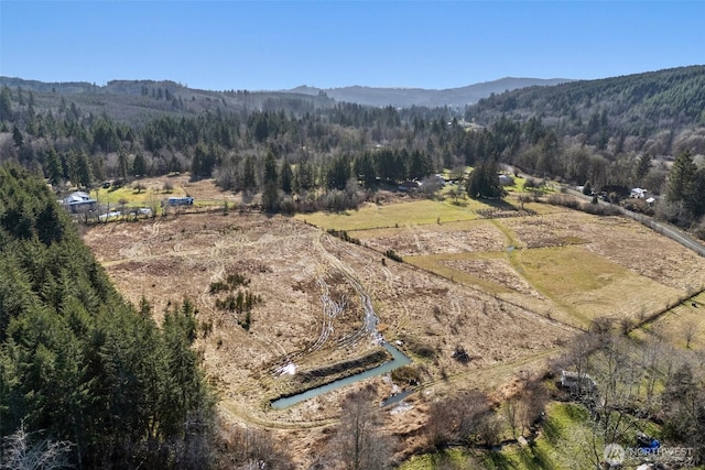 bird's eye view with a mountain view and a wooded view