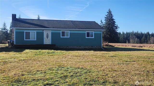 view of front of house with crawl space, a chimney, and a front yard