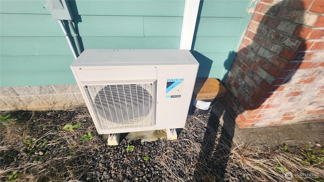 exterior details with brick siding and ac unit