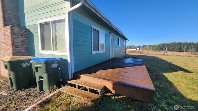 view of side of property with a deck and a yard