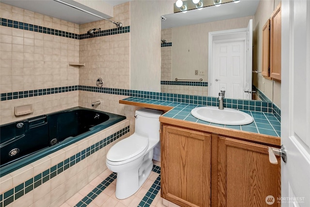 full bath featuring tile patterned flooring, tiled shower / bath combo, vanity, and toilet