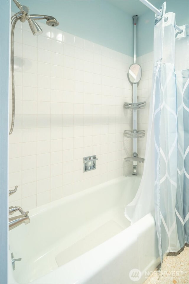 bathroom with shower / tub combo with curtain