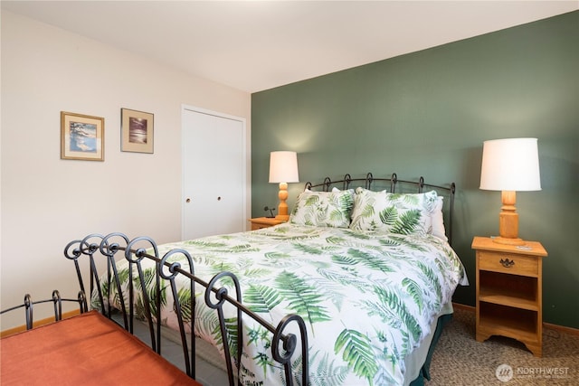 bedroom featuring carpet and baseboards