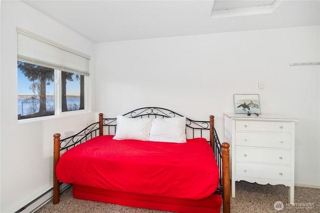 bedroom with baseboard heating and carpet