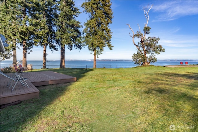 view of yard with a deck with water view