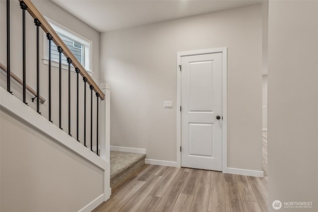 stairs with baseboards and wood finished floors