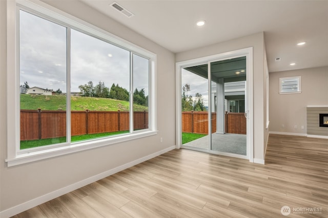 entryway with baseboards, light wood-style floors, visible vents, and recessed lighting
