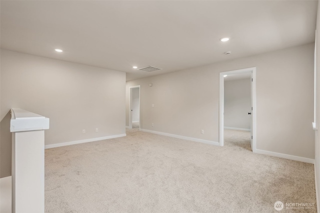 spare room featuring recessed lighting, baseboards, visible vents, and light colored carpet
