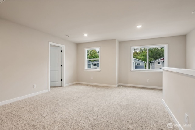 unfurnished room featuring baseboards, recessed lighting, and light colored carpet