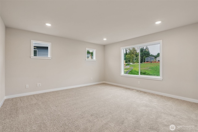 carpeted spare room with baseboards and recessed lighting