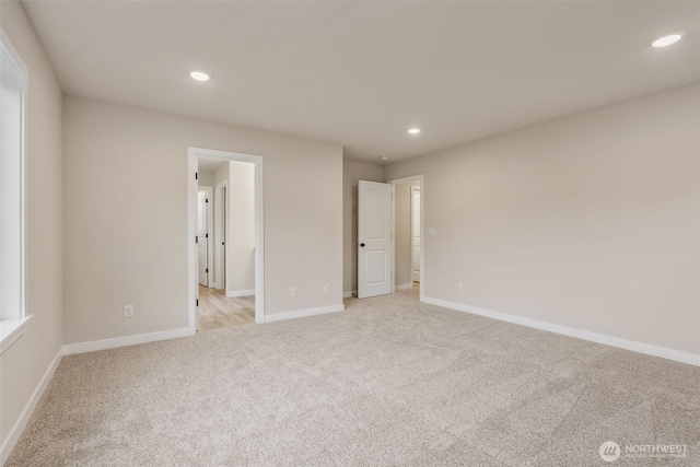 unfurnished bedroom featuring baseboards, recessed lighting, and light colored carpet