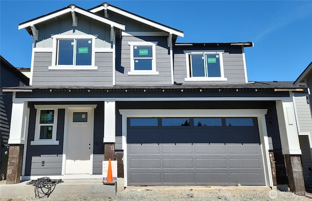 craftsman-style home with an attached garage and covered porch