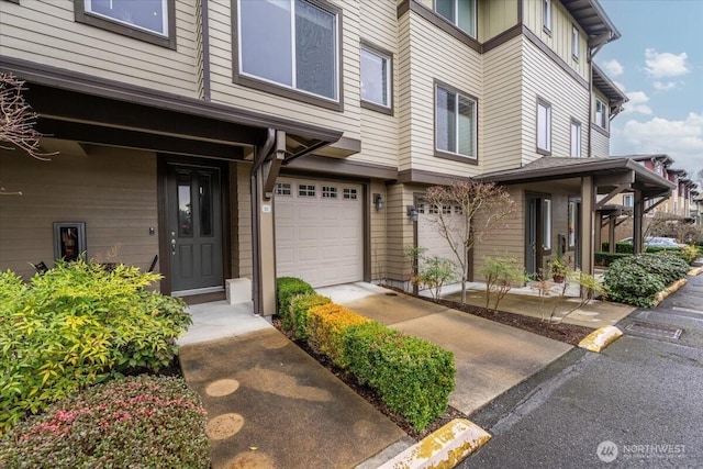 view of exterior entry featuring an attached garage