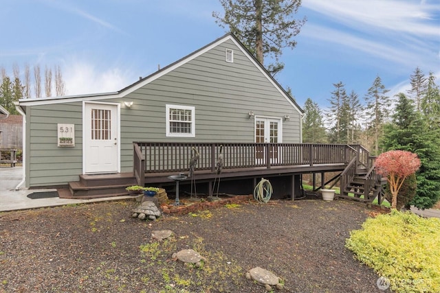 rear view of property featuring a wooden deck