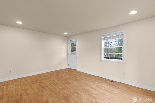 unfurnished room with visible vents, recessed lighting, light wood-style flooring, and baseboards